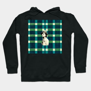 Peaceful young girl profile on a plaid background. Hoodie